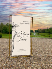 Panneau de bienvenue mariage personnalisé en toile beige avec grande fleur noire – design épuré – Collection Bloom, design 1